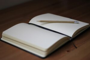 Notebook and pen — how to stop stressing about money journal