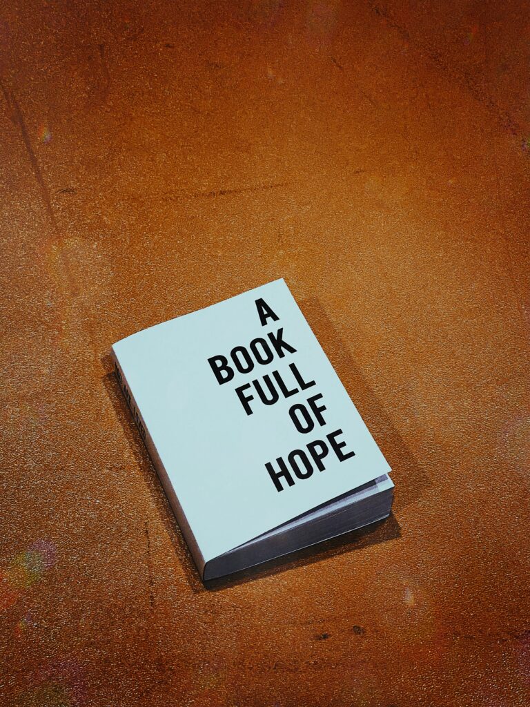 “A closed book with the title ‘A Book Full of Hope’ on the cover, symbolizing emotional recovery and finding hope after financial burnout