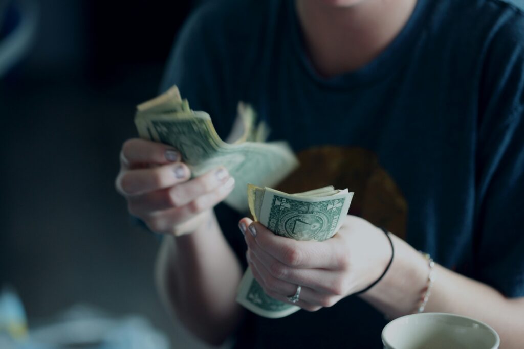 Woman counting some money after getting paid.